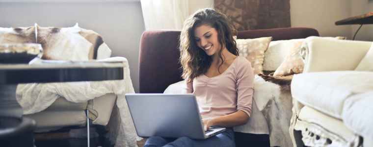 woman smiling while using laptop
